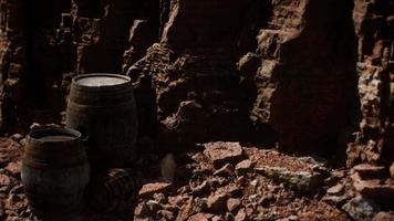 old wooden vintage wine barrels near stone wall in canyon video