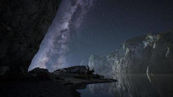 hyperlapse of night starry sky with mountain and ocean beach in Lofoten Norway