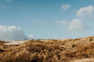 Man walking on dunes photo