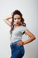 Studio portrait of girl with asian appearance and bright make up with red star on forehead photo