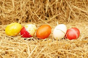 Close up of Easter eggs stack on straw backgrounds photo
