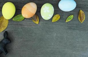 Still life with easter eggs and atum leaves on wood backgrounds above. Place for your text photo