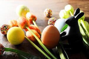 Close up of Easter decoration and rabbit doll and tulips flower photo