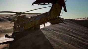 old rusted military helicopter in the desert at sunset video