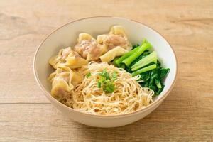 dried egg noodles with pork wonton or pork dumplings without soup photo
