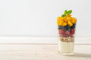 homemade mango, raspberry and blueberry with yogurt and granola photo