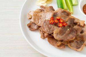 grilled pork neck sliced on plate photo