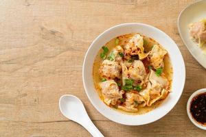 pork wonton soup or pork dumplings soup with roasted chili photo