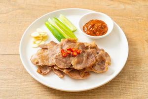 grilled pork neck sliced on plate photo