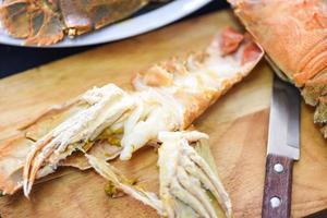 Flathead lobster shrimps on wooden cutting board, boiled slipper lobster flathead for cooking in the kitchen photo