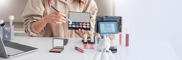 Makeup Beauty fashion blogger recording video presenting cosmetics at home influencer on social media concept. photo