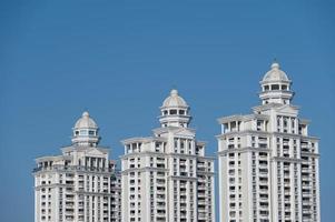 A row of white European style buildings are under the blue sky photo