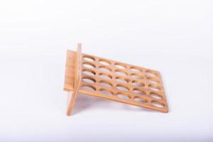 The small item storage rack made of bamboo is on a white background photo