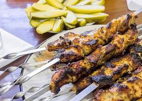 delicious crispy kebab on skewers on the plate photo