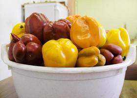 Red and yellow sweet bell peppers on table, close up photo