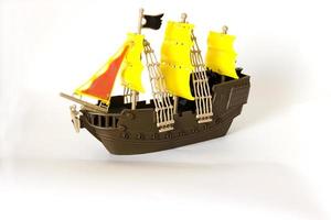 Toy wooden ship circling isolated on white background