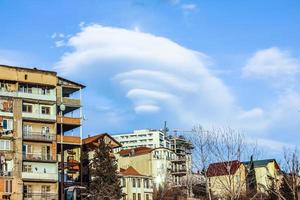 Beautiful clouds of unusual shape. Urban landscape with beautiful couds in the sky. photo