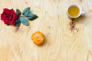 Fresh banana and persimmon in brick wall background and wooden table, photo