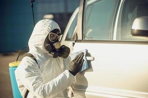 Cleaning and Disinfection of vehicles amid the coronavirus epidemic Car cleaning and disinfection Infection prevention and control of epidemic Protective suit and mask photo