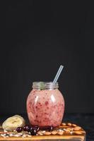 freshly prepared smoothies from banana and blackberry in bottle. Diet, healthy lifestyle photo