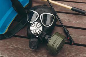 A protective mask and knapsack for disinfection lie on a bench in the urban complex Protection and prevention of the coronavirus epidemic photo