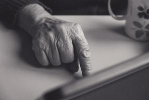 Elder woman hand pointing at something. photo