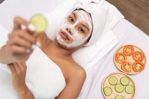 Portrait of young beautiful asian woman enjoys massage in a luxury spa resort photo