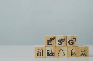 Wooden cubes with ESG Environmental Social Governance symbol on background and copy space.Business concepts. photo