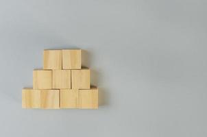 Blank wooden cubes for icons or symbols on gray background. photo