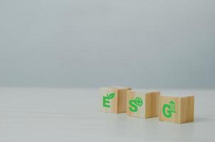 Wooden cubes with ESG Environmental Social Governance symbol on background and copy space.Business concepts. photo