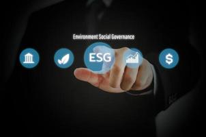 Businessman touching ESG Environmental Social Governance virtual screen Internet Business Technology Concept. photo