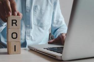 Wooden cubes with ROI Return on Investment symbol on background and copy space.Business concepts. photo