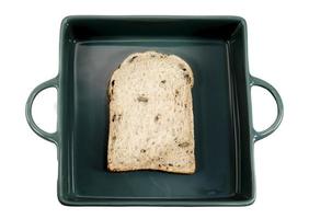 Whole wheat bread slice in green tray