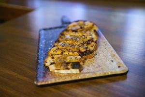 Cut toast of foie served on board photo