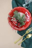 Christmas table decoration. Christmas dinner plate, cutlery decorated festive decorations. Winter holidays. Christmas card. Free space for your text. Merry Christmas, Happy New Year. photo
