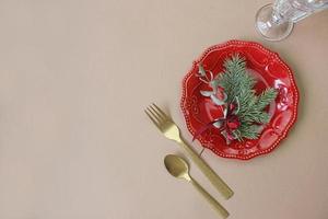 Christmas table decoration. Christmas dinner plate, cutlery decorated festive decorations. Winter holidays. Christmas card. Free space for your text. Merry Christmas, Happy New Year. photo