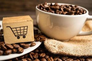 Box with shopping cart logo symbol on coffee beans, Import Export Shopping online or eCommerce delivery service store product shipping, trade, supplier concept. photo