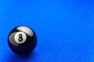 Eight billiard ball in a blue pool table. photo