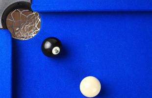 Match ball. Black eight ball in the pocket. photo