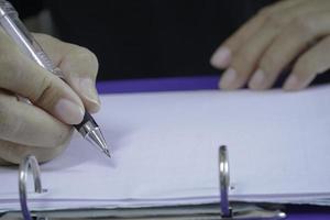 Close up image of businesswoman signing contract. photo