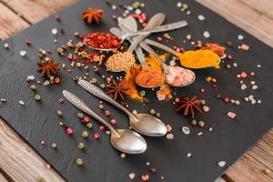 Spices and herbs on old kitchen table. Food and cuisine ingredients photo