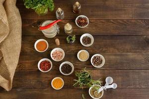 Spices and herbs on old kitchen table. Food and cuisine ingredients photo