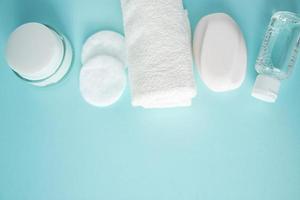 Spa accessories and cosmetics for skin care on blue background. photo