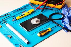 Flat lay image of dismantling the broken smart phone for preparing to repair or replace some components, Top view photo