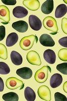 Slices and half of avocado on a yellow wallpaper background. photo