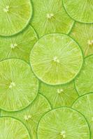 Fruit pattern of lime slices background. Top view. photo