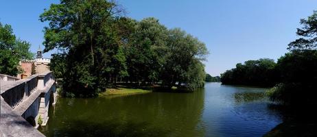 old castle with lake in summer panorama photo