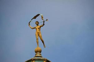 golden figure on a roof photo