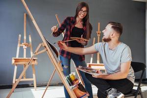 Artists paint pictures in the studio. Creative artists have designed a colorful picture painted on canvas with oil paints photo