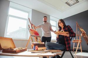 Group of students painting at art lessons photo